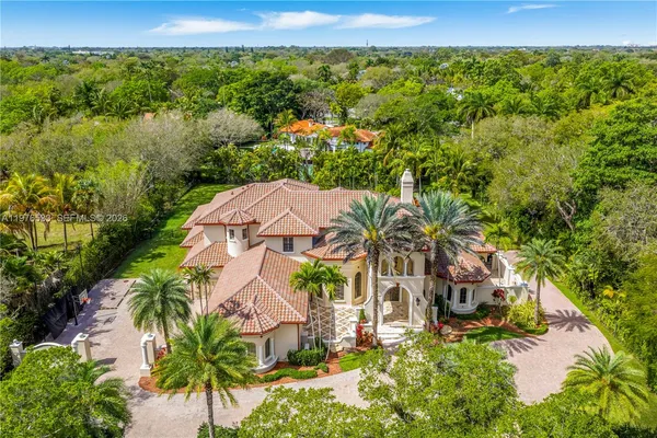 an aerial view of a house with garden space and street view