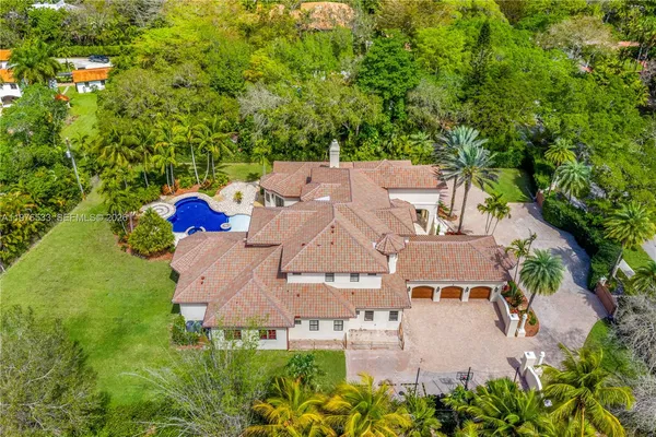 an aerial view of a house with yard swimming pool and outdoor seating