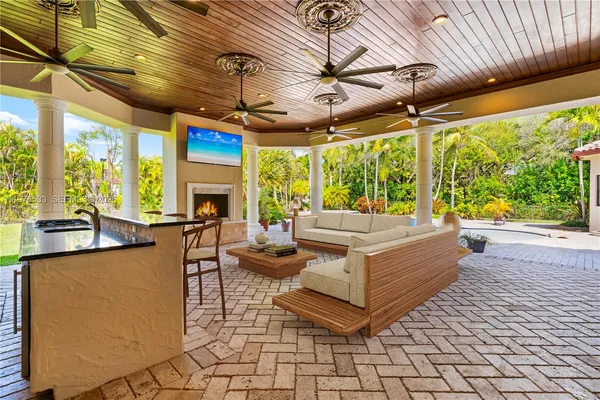 a living room with patio furniture and a fireplace