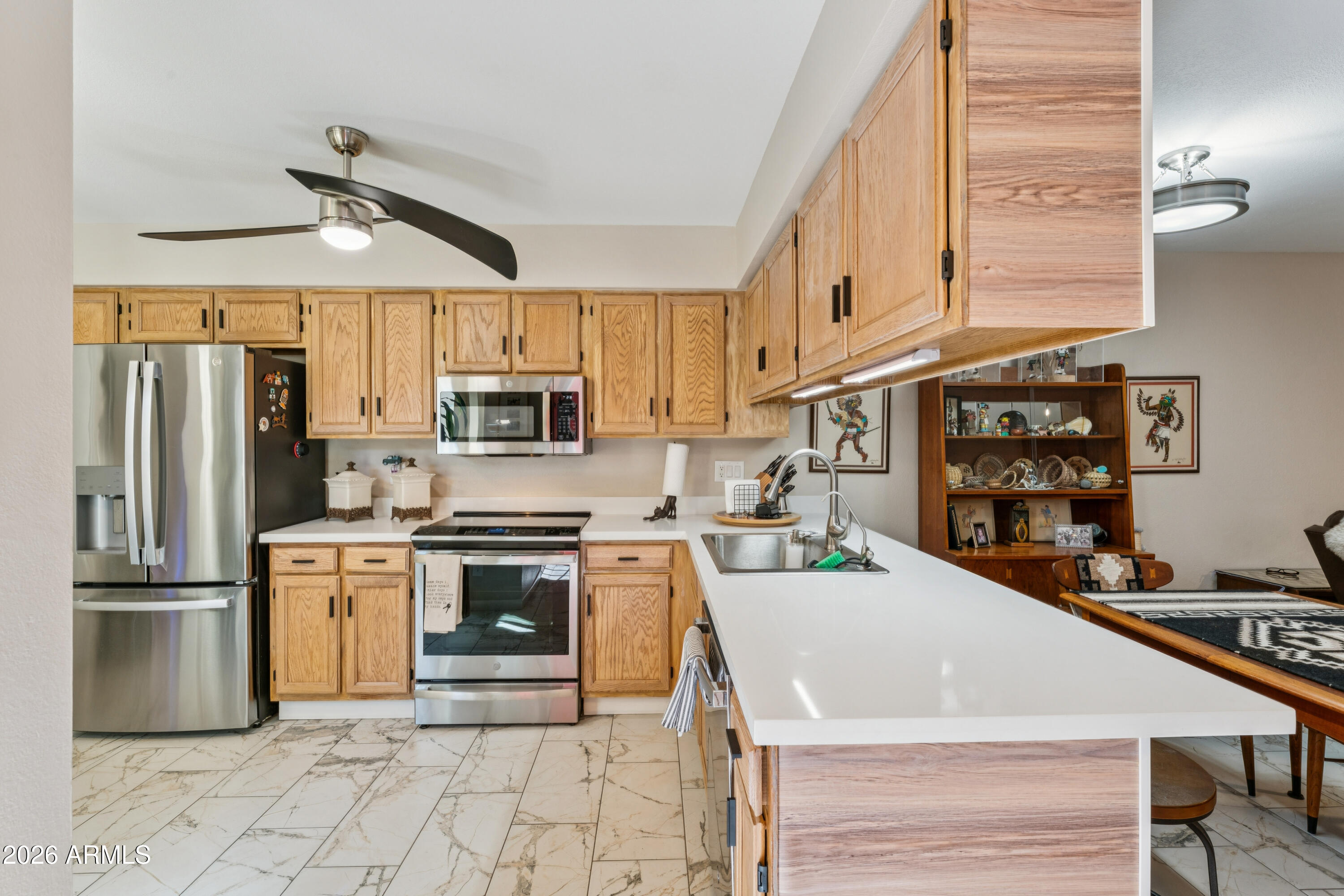 6027 South Alameda Road Gold Canyon, AZ 85118 - Photo 12 of 27 a kitchen with stainless steel appliances granite countertop a stove refrigerator sink and cabinets
