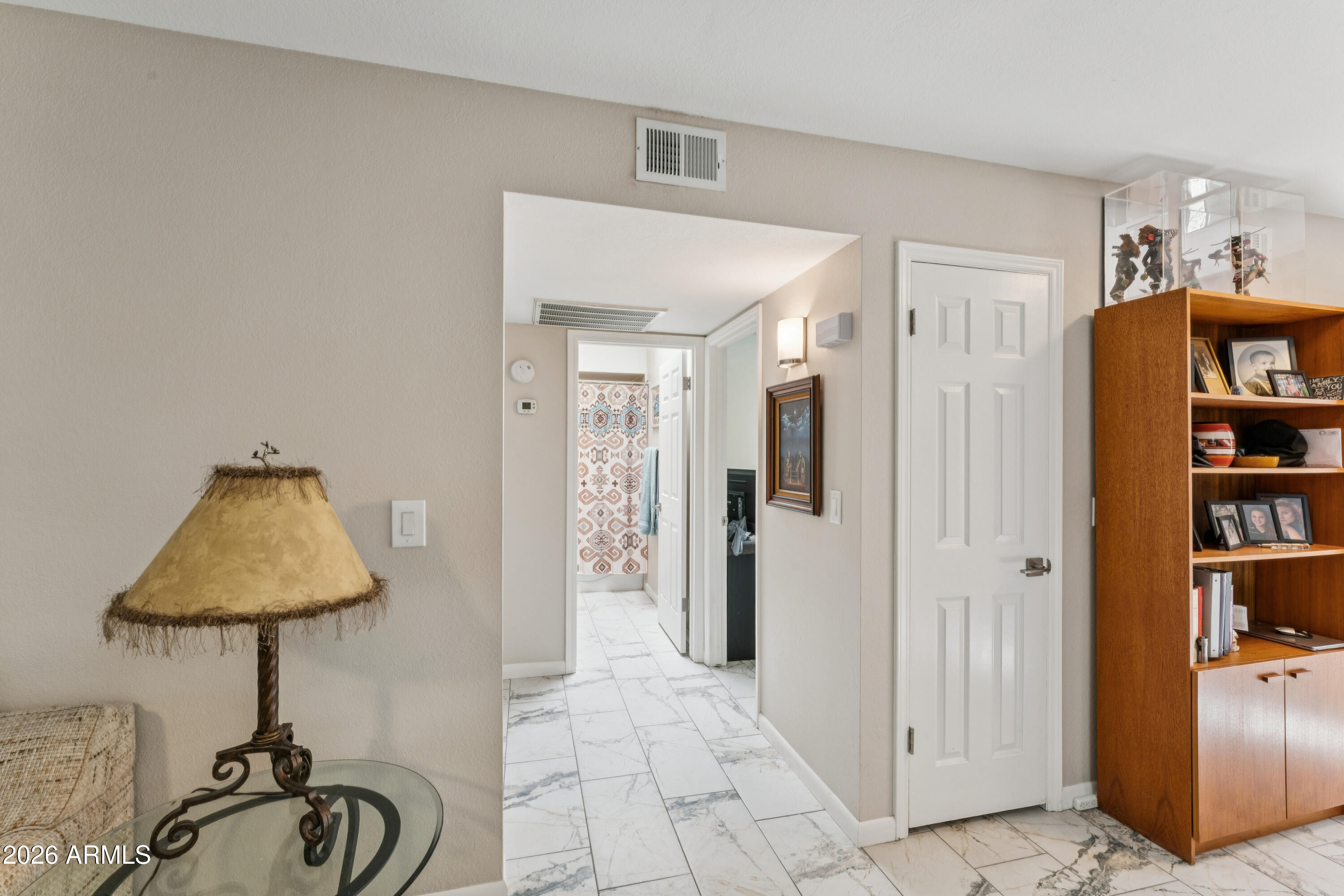 6027 South Alameda Road Gold Canyon, AZ 85118 - Photo 16 of 27 a view of a livingroom with a table & a refrigerator