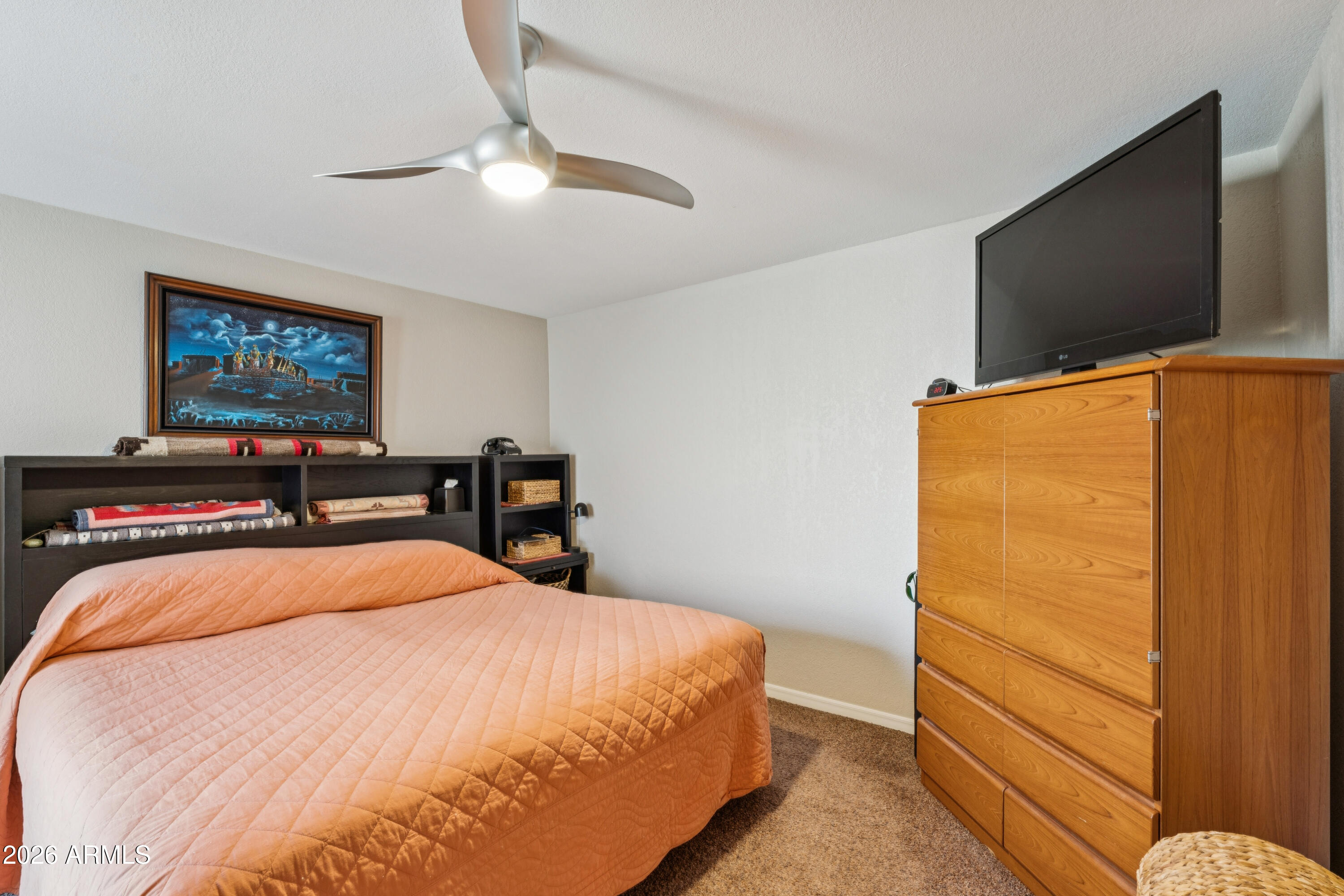 6027 South Alameda Road Gold Canyon, AZ 85118 - Photo 17 of 27 a bedroom with a bed and a flat screen tv