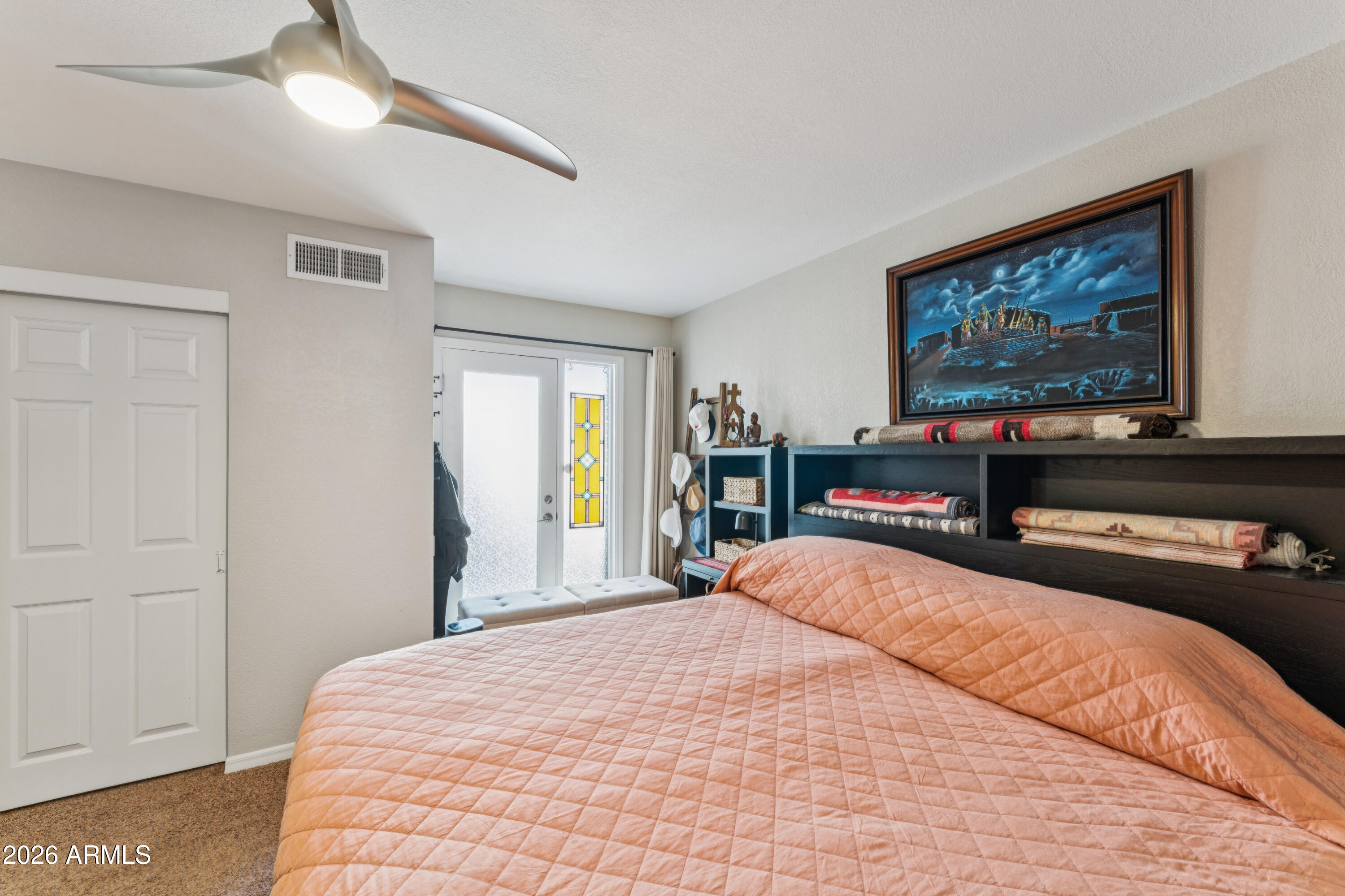 6027 South Alameda Road Gold Canyon, AZ 85118 - Photo 18 of 27 a bedroom with a bed and glass wall