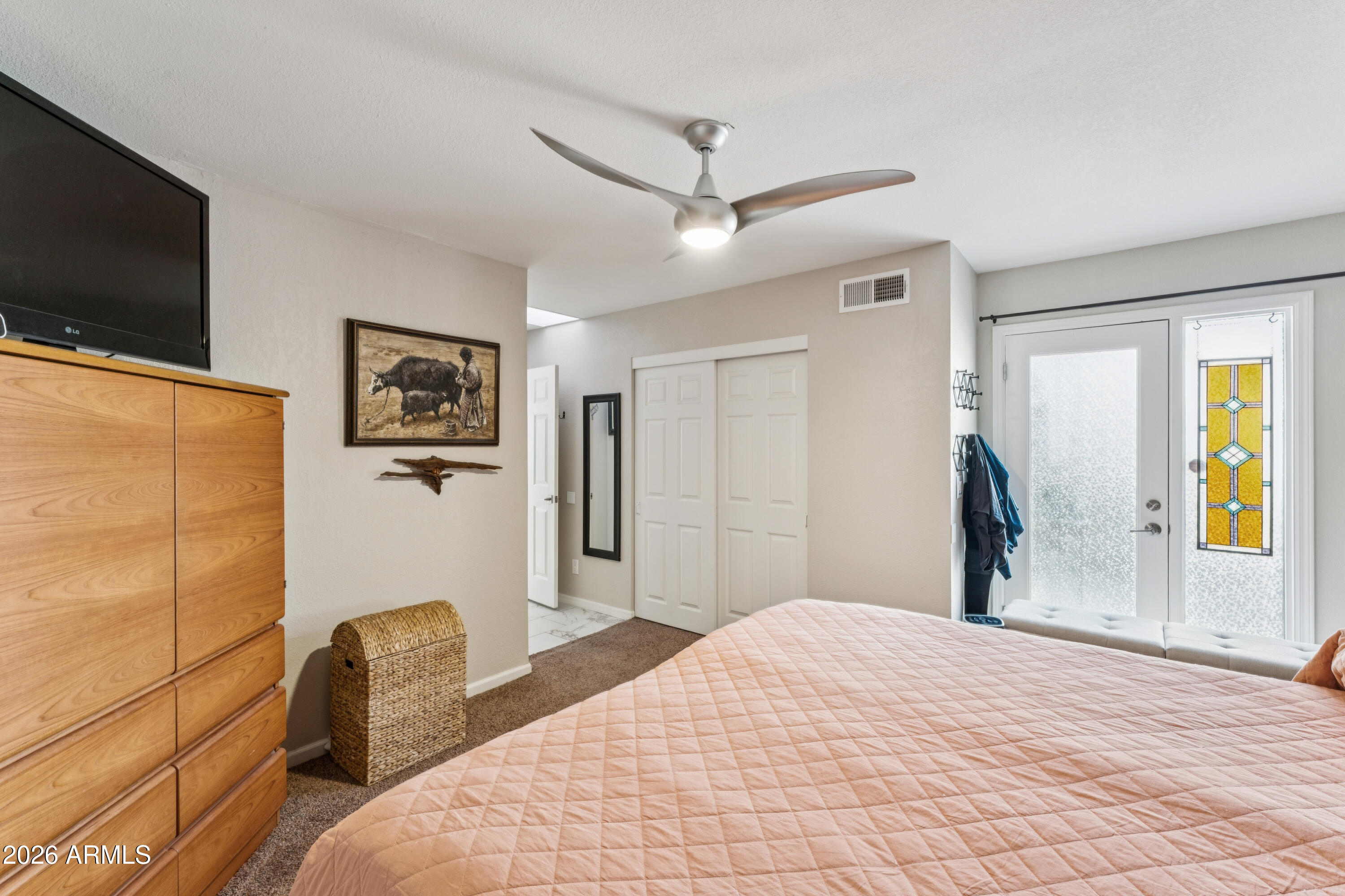 6027 South Alameda Road Gold Canyon, AZ 85118 - Photo 19 of 27 a bedroom with a bed and a flat screen tv