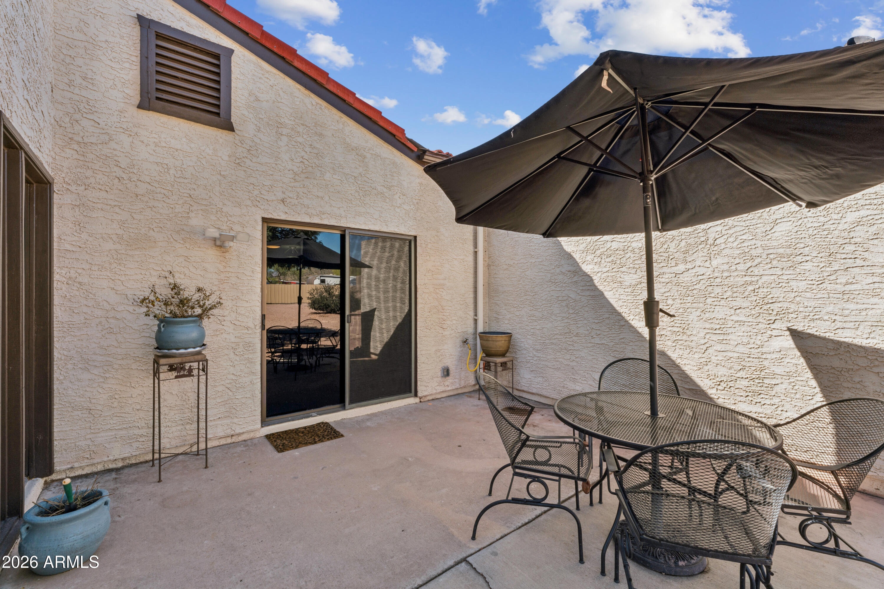 6027 South Alameda Road Gold Canyon, AZ 85118 - Photo 23 of 27 a patio with table and chairs