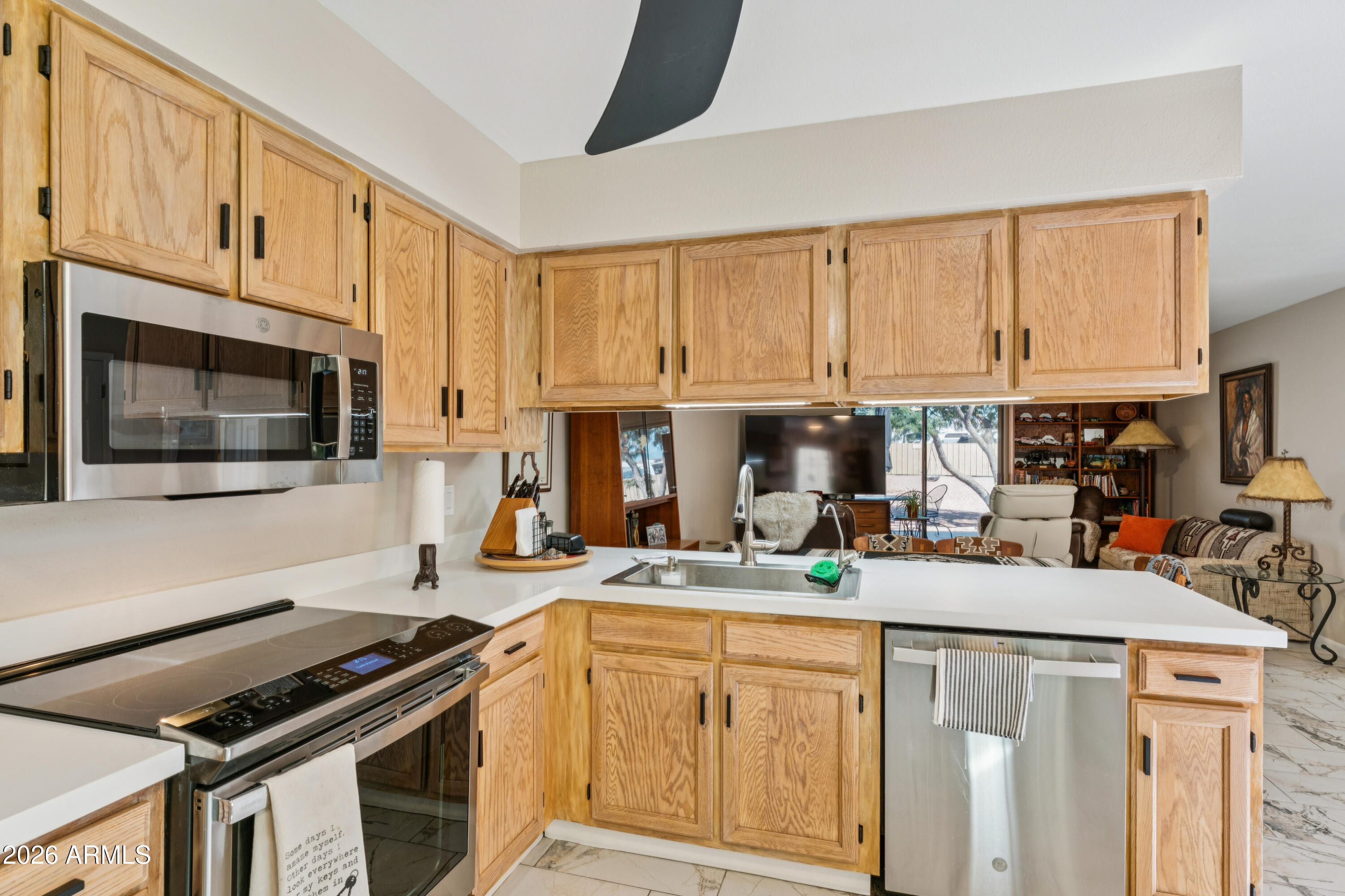 6027 South Alameda Road Gold Canyon, AZ 85118 - Photo 10 of 27 a kitchen with stainless steel appliances a stove a sink a stove and cabinets
