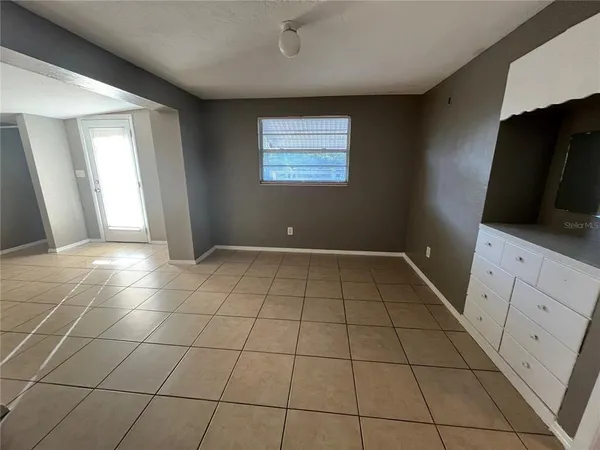 a view of a livingroom with an empty space and a window