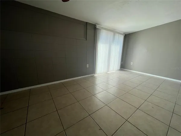 a view of an empty room and wooden shelves