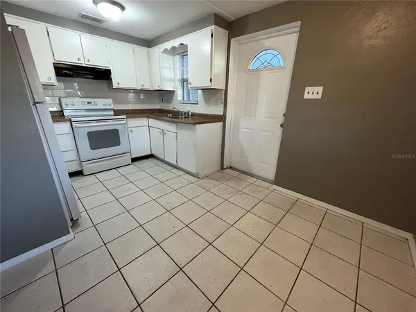 a kitchen with stainless steel appliances a refrigerator sink and microwave