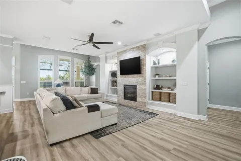 a living room with fireplace furniture and a flat screen tv