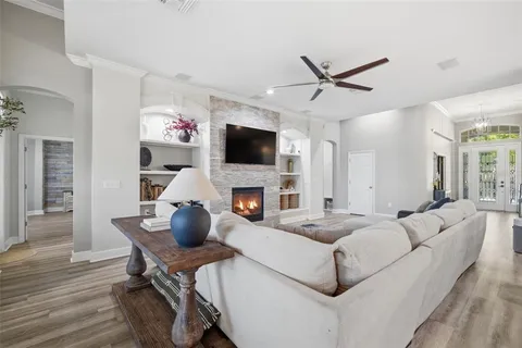 a living room with fireplace furniture and a flat screen tv