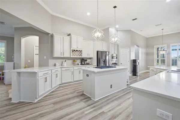 a bed sitting in a spacious bedroom next to a window