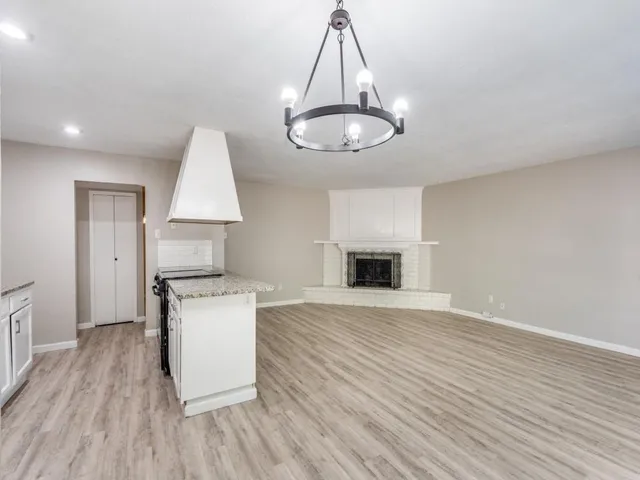 a kitchen with stainless steel appliances a stove top oven a sink and cabinets