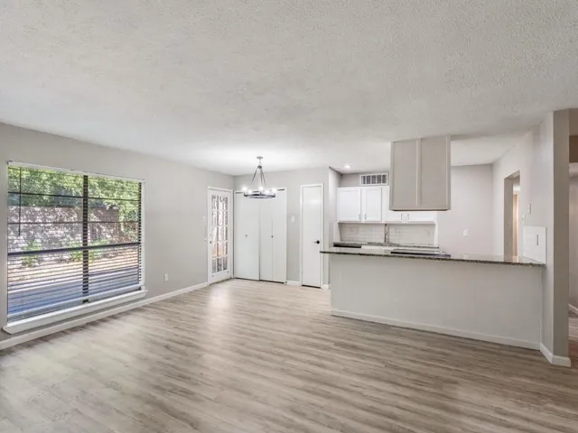 a view of a kitchen with a sink and wooden floor