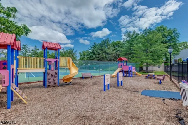 a view of outdoor space with playground and green space