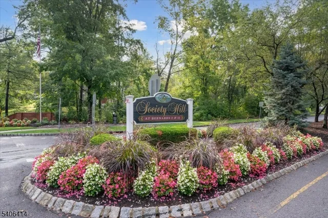 a sign that is in front of flowers