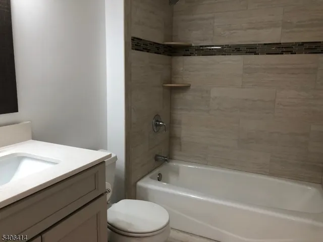 a bathroom with a bathtub a sink and toilet