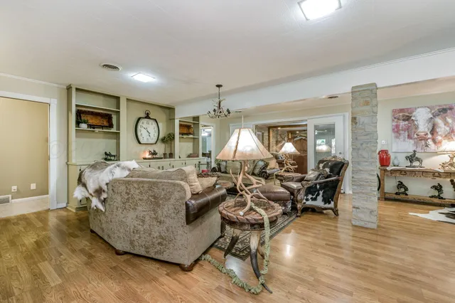 a living room with furniture and a chandelier