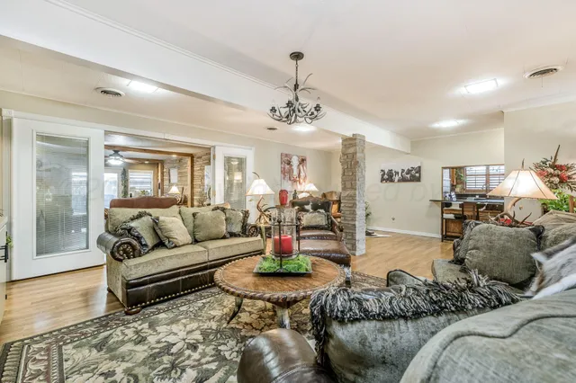 a living room with furniture and a chandelier