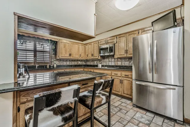 a kitchen with stainless steel appliances granite countertop white cabinets sink and dishwasher