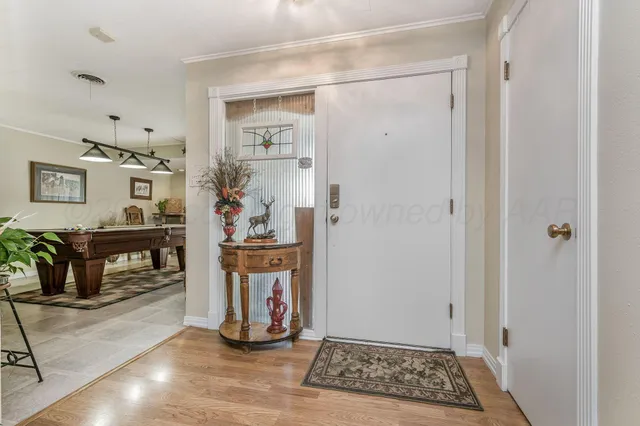 a room with furniture pool table and windows