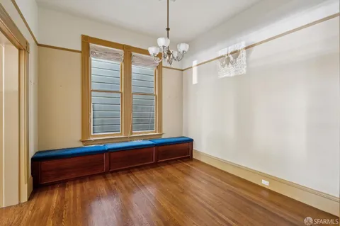 a view of a room with wooden floor chandelier and entryway