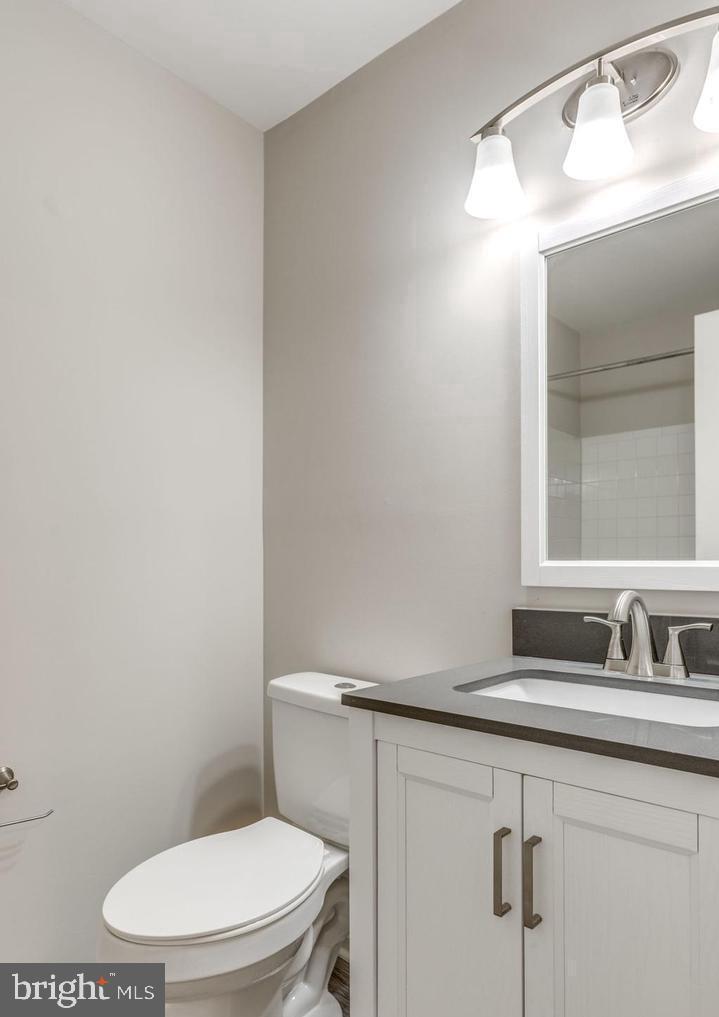 340 Lancaster Square Sterling, VA 20164 - Photo 8 of 12 a bathroom with a toilet a sink and mirror