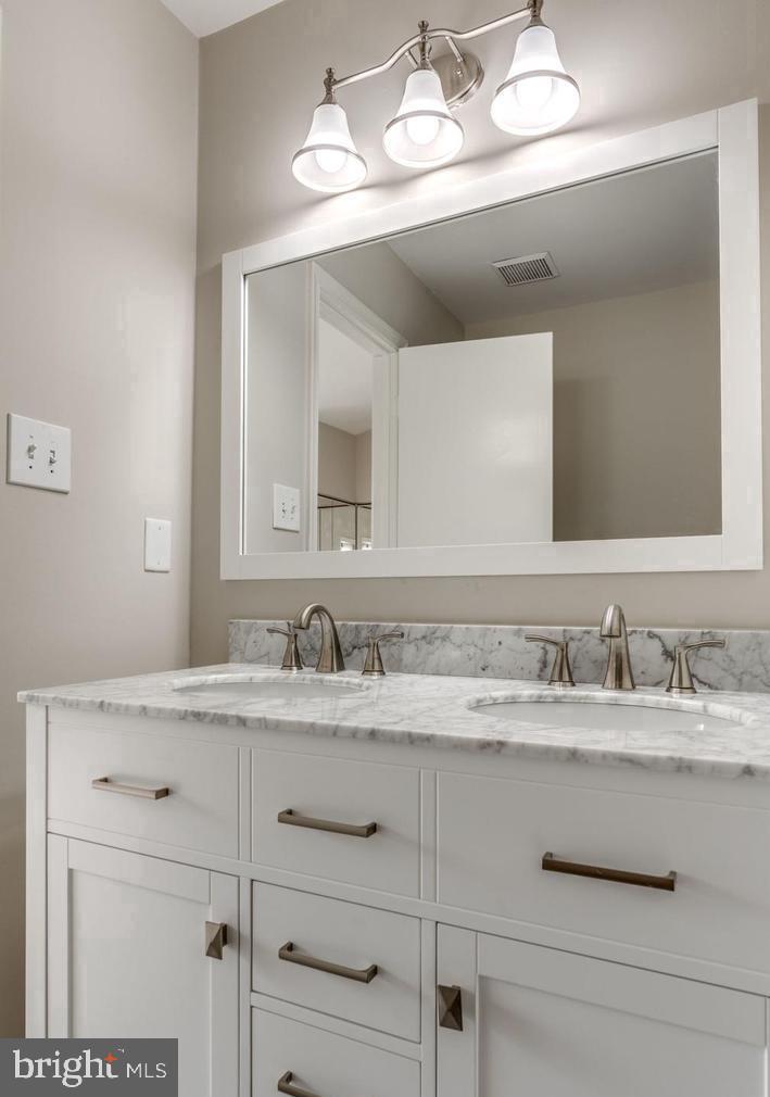 340 Lancaster Square Sterling, VA 20164 - Photo 9 of 12 a bathroom with a sink vanity and a mirror