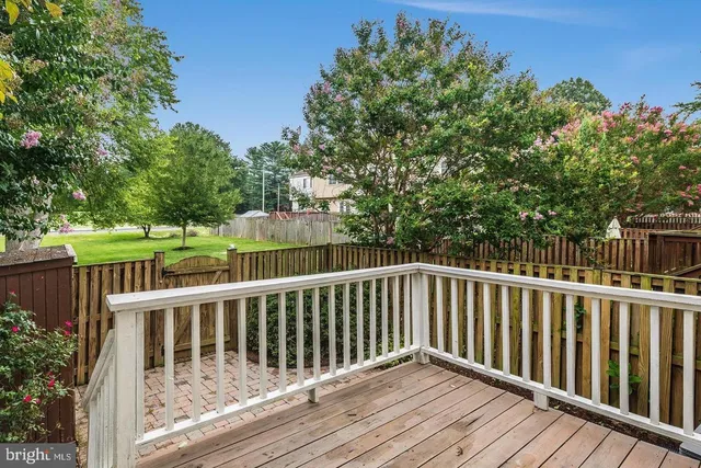 a balcony with wooden floor and fence