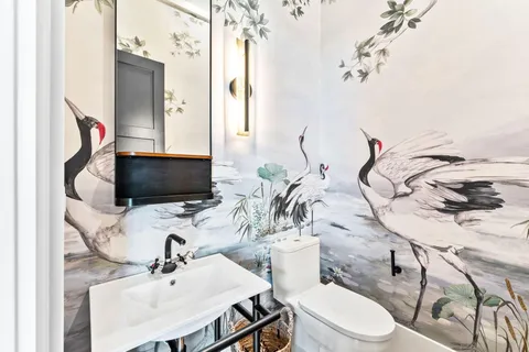 a living room with furniture a rug and a chandelier