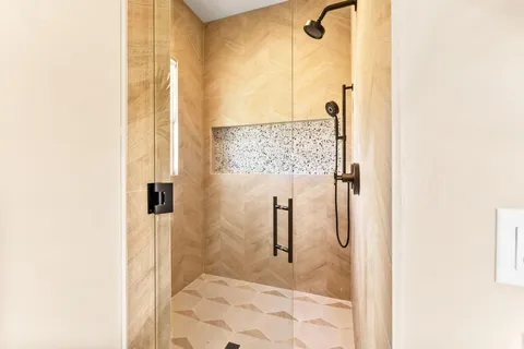 a bathroom with a toilet and a shower