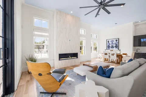 a living room with furniture a wooden floor and a window