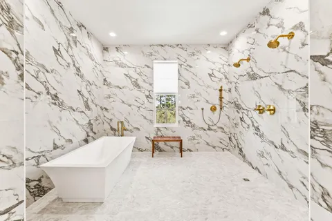 a spacious bedroom with a large bed and a chandelier