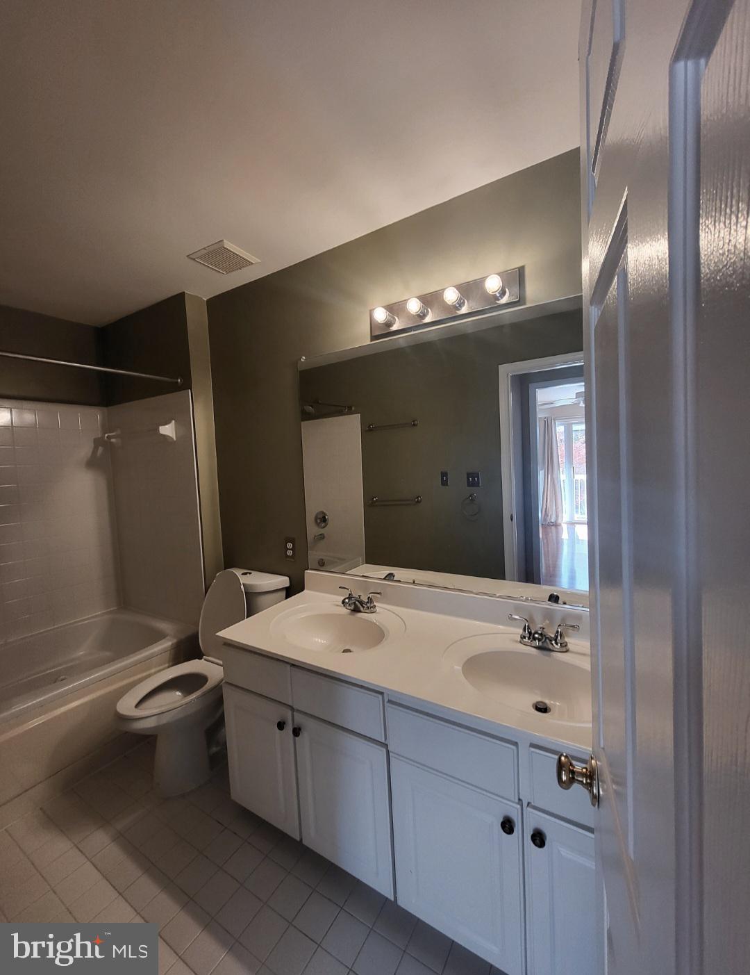 1970 Crescent Park Drive, Unit 19A Reston, VA 20190 - Photo 4 of 9 a spacious bathroom with a double vanity sink toilet and shower