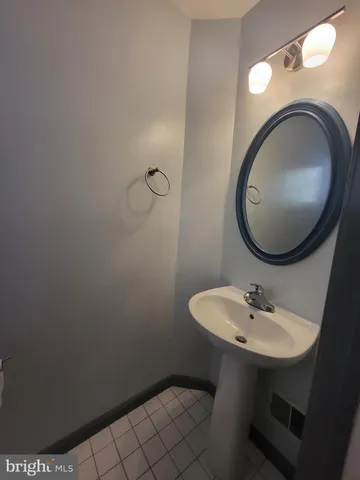 a bathroom with a sink mirror and toilet