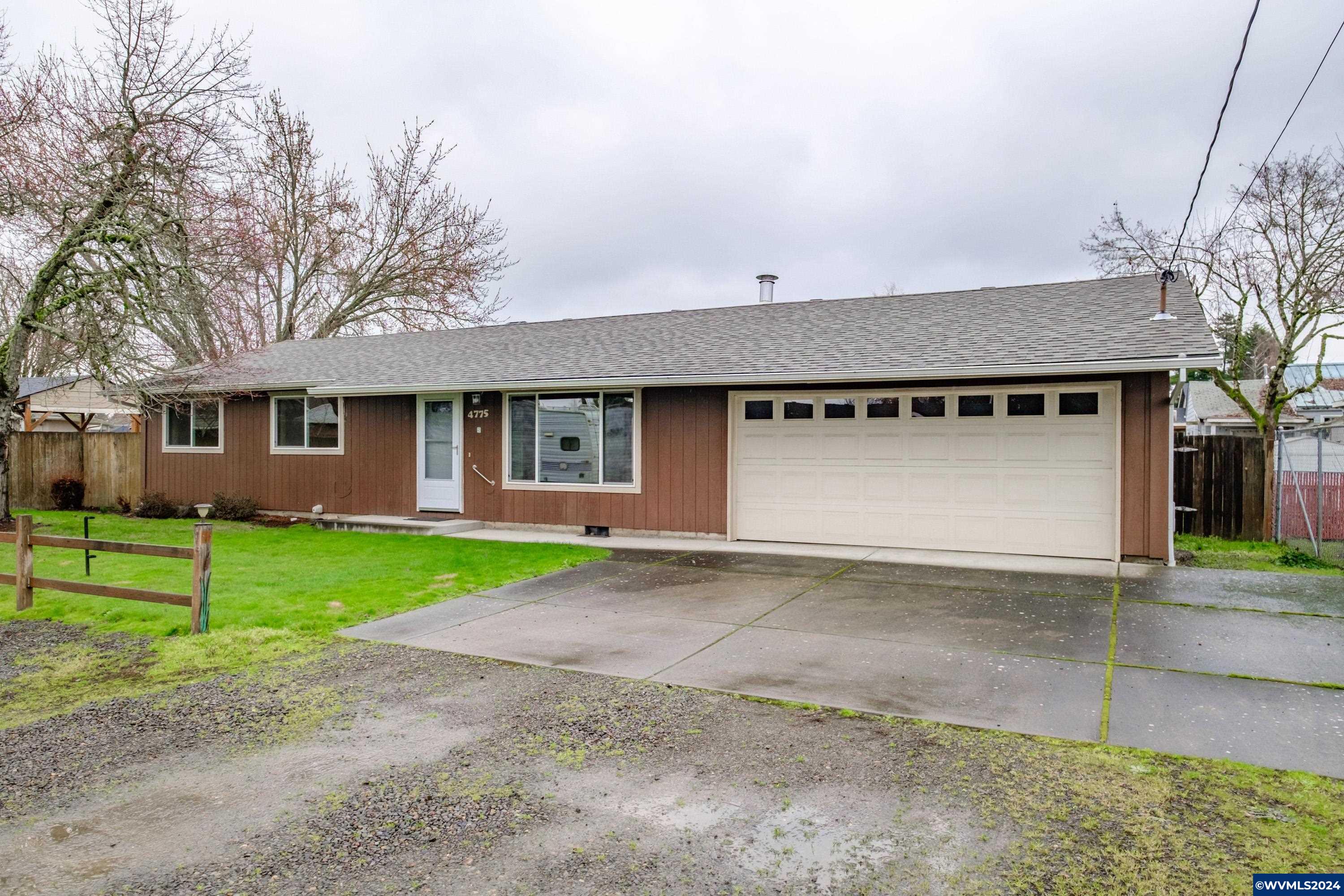 4775 Swegle Road Northeast Salem, OR 97305 - Photo 7 of 38 a front view of a house with a yard and garage