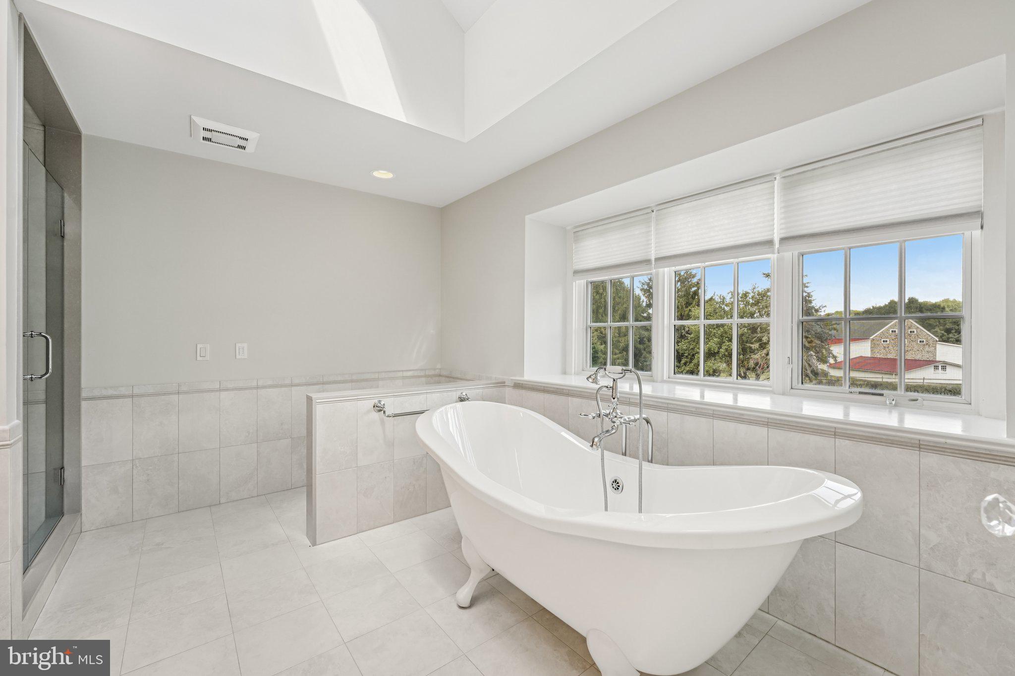 12 Paddock Drive New Hope, PA 18938 - Photo 23 of 42 a white bath tub sitting in a bathroom next to a window
