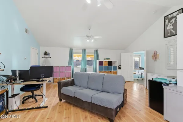 a living room with furniture and a wooden floor