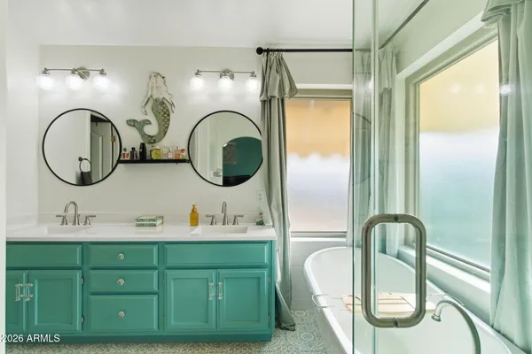 a bathroom with a double vanity sink and a mirror