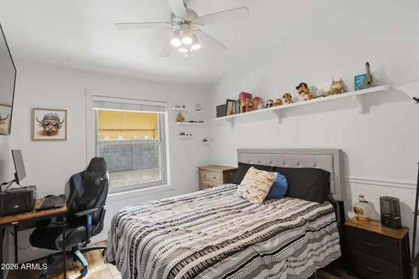 a bedroom with bed and a window