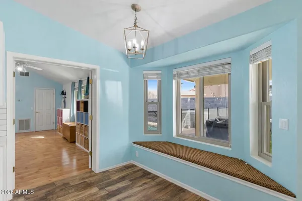 a very nice looking room with wooden floor and furniture
