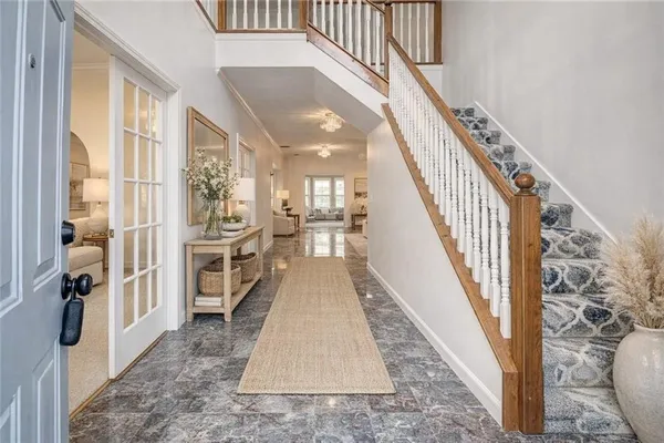 a view of entryway and hall with wooden floor