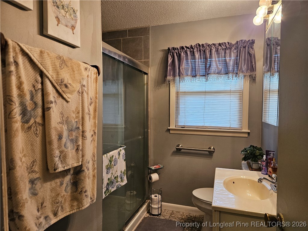 4547 Legion Road Hope Mills, NC 28348 - Photo 15 of 24 a bathroom with a bathtub shower sink and mirror