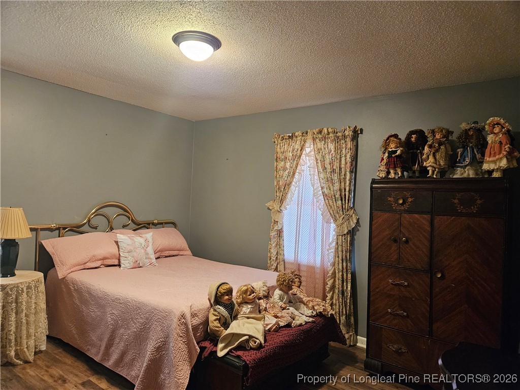 4547 Legion Road Hope Mills, NC 28348 - Photo 16 of 24 a bedroom with a bed and a closet