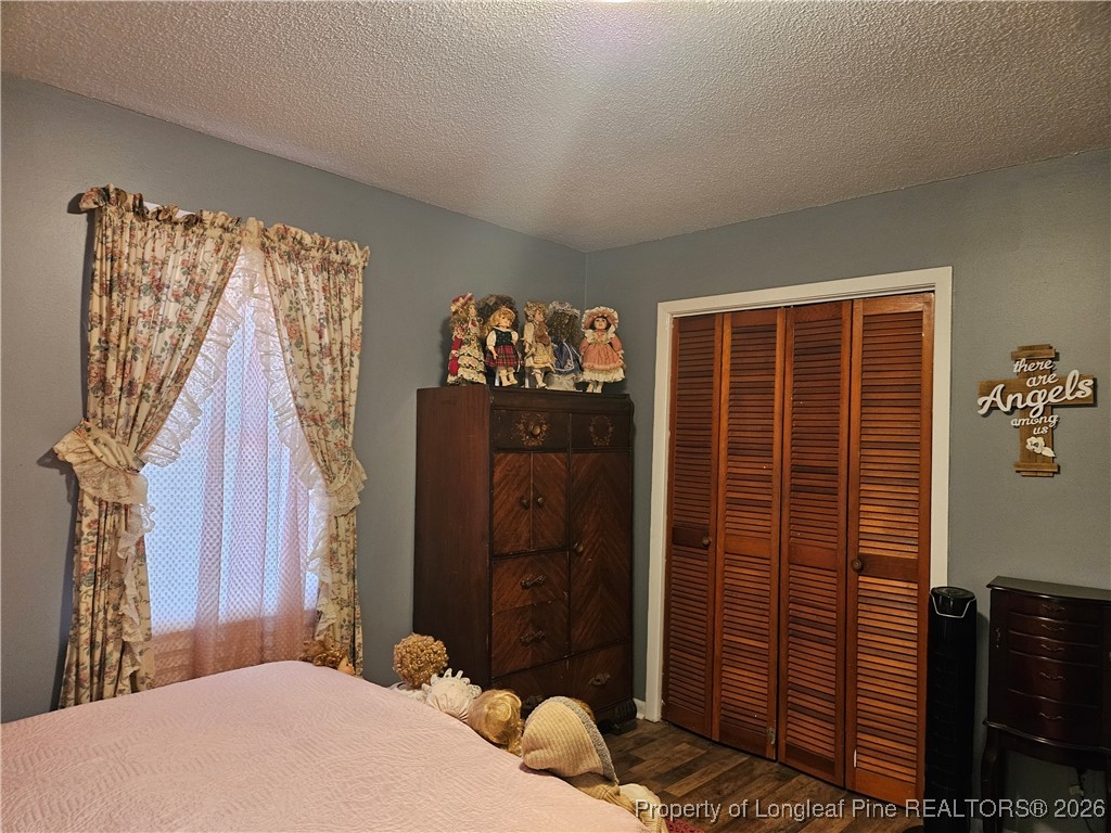 4547 Legion Road Hope Mills, NC 28348 - Photo 17 of 24 a bedroom with a bed and a closet