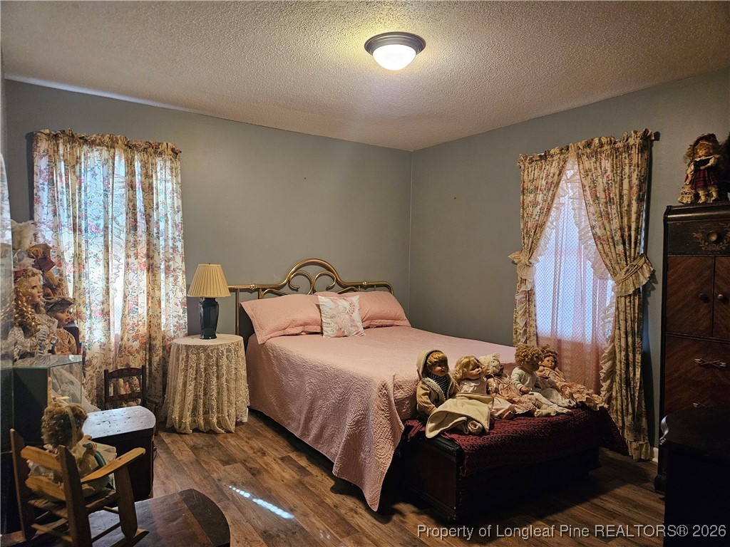 4547 Legion Road Hope Mills, NC 28348 - Photo 18 of 24 a bedroom with a bed and a couch