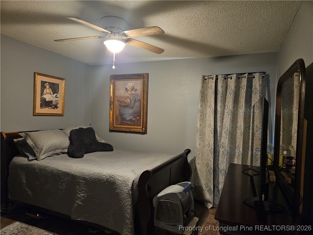 4547 Legion Road Hope Mills, NC 28348 - Photo 19 of 24 a bedroom with a bed and a painting on the wall