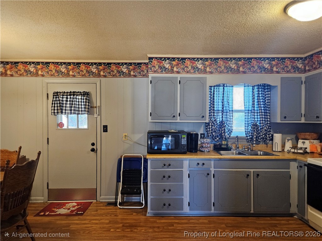 4547 Legion Road Hope Mills, NC 28348 - Photo 8 of 24 a kitchen with stainless steel appliances granite countertop a sink stove and cabinets