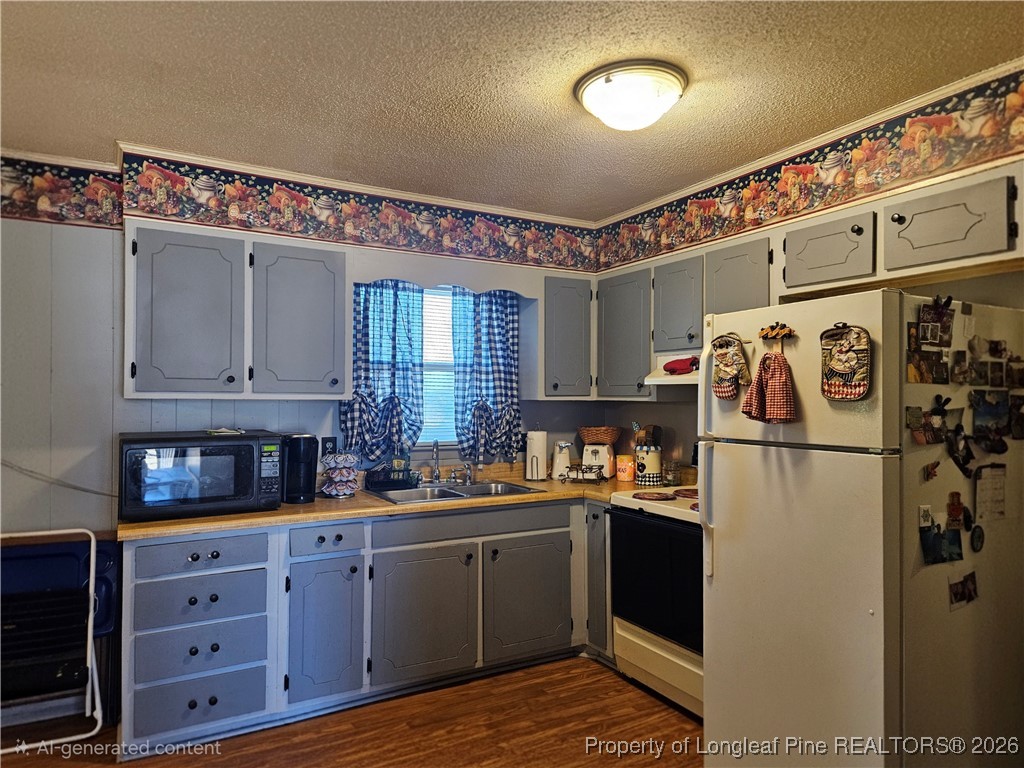 4547 Legion Road Hope Mills, NC 28348 - Photo 9 of 24 a kitchen with refrigerator and cabinets