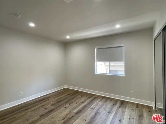 a room with wooden floor and window